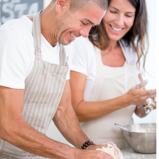 man and woman making pasta