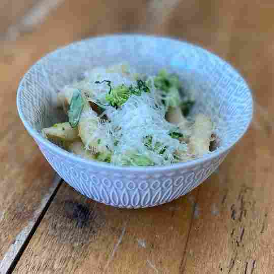 Penne noodles with broccoli, romano beans, and Parmesan cheese.